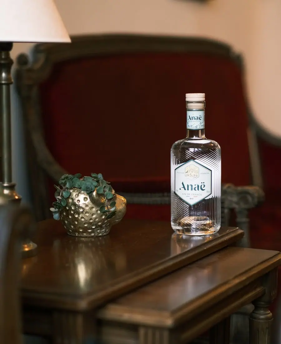 Tall slender aquavit bottle with a pale straw tint and a sprig of dill alongside