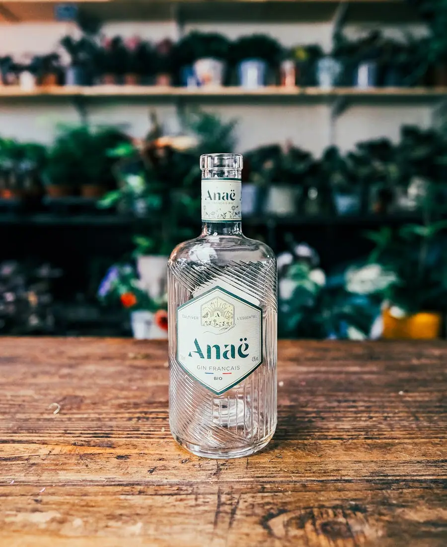 Frosted clear vodka bottle with a kraft-paper label standing on weathered driftwood