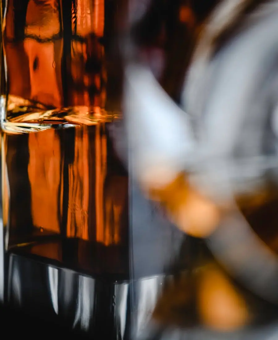 Hand-numbered single-barrel whiskey bottle with deep amber liquid and a tin seal